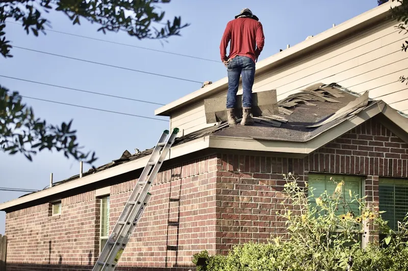 Professional roofer working on a residential roof in Old North Columbus